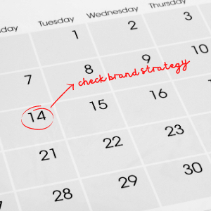 Calendar with date circled and check brand strategy in writing